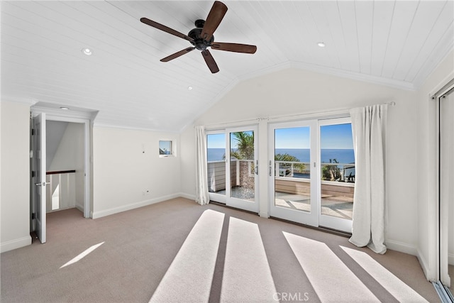 interior space with light colored carpet, ornamental molding, baseboards, and vaulted ceiling