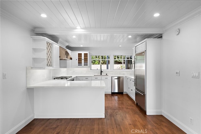 kitchen featuring a peninsula, open shelves, light countertops, glass insert cabinets, and appliances with stainless steel finishes