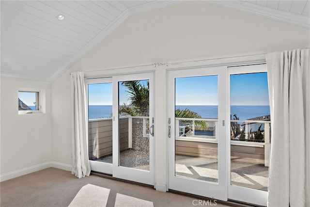 doorway to outside with baseboards, a water view, carpet floors, ornamental molding, and vaulted ceiling