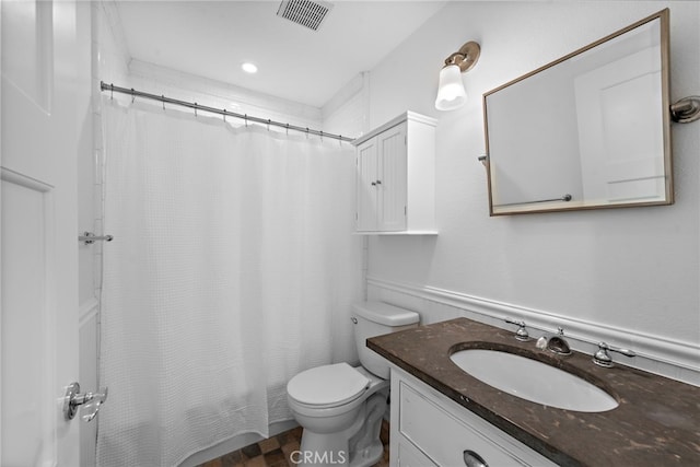 bathroom with vanity, toilet, and visible vents