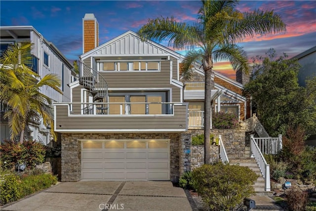 1020 La Mirada St, Laguna Beach, CA 92651 - view of front of property with stairway, an attached garage, driveway, stone siding, and board and batten siding