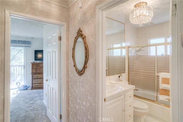 full bath with toilet, an inviting chandelier, combined bath / shower with glass door, vanity, and a textured ceiling
