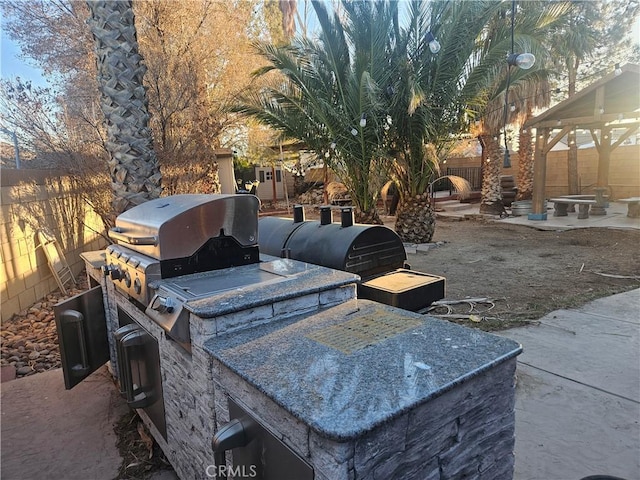 view of patio / terrace with a gazebo, grilling area, area for grilling, and a fenced backyard