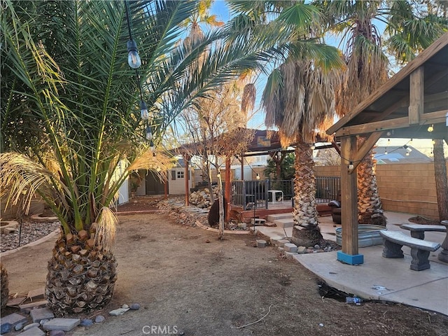 view of yard featuring fence and a patio