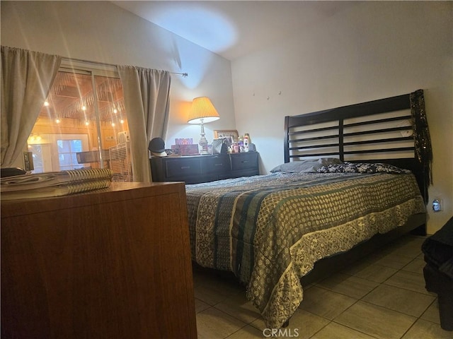 bedroom with tile patterned flooring and vaulted ceiling