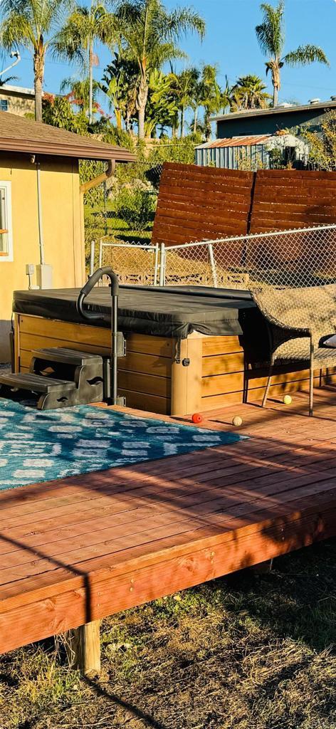 exterior space with fence and a hot tub