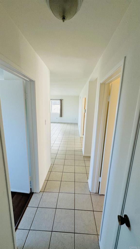 hall featuring light tile patterned floors