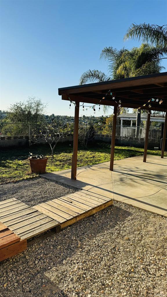 view of community featuring fence and a patio