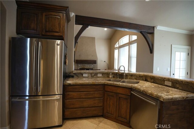 25841 Remington Ct, Tehachapi, CA 93561 - kitchen with light tile patterned floors, stone counters, stainless steel appliances, a sink, and dark brown cabinets
