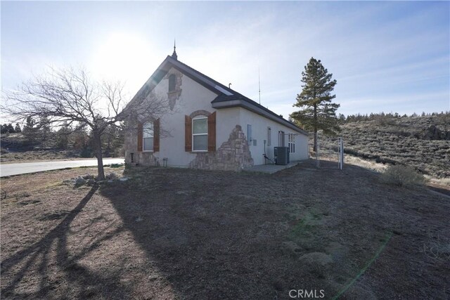 25841 Remington Ct, Tehachapi, CA 93561 - view of side of property with central AC unit and stucco siding