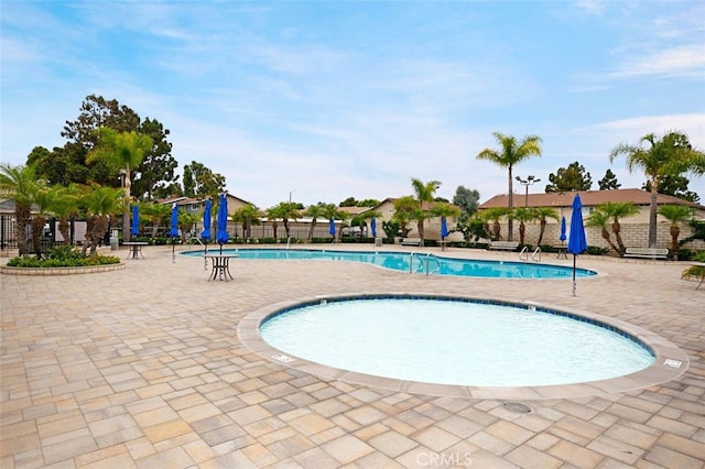 pool featuring a patio area and fence