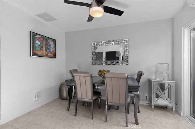 dining area with baseboards, visible vents, ceiling fan, and light tile patterned flooring