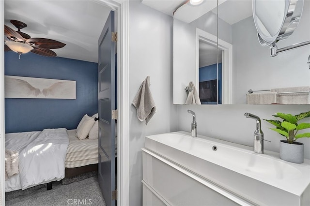 ensuite bathroom with a ceiling fan, connected bathroom, and vanity