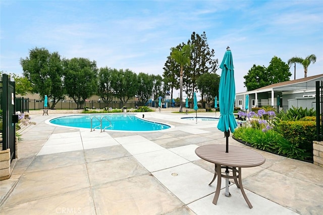 pool featuring a patio area and fence