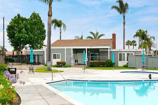 pool featuring a patio area and fence