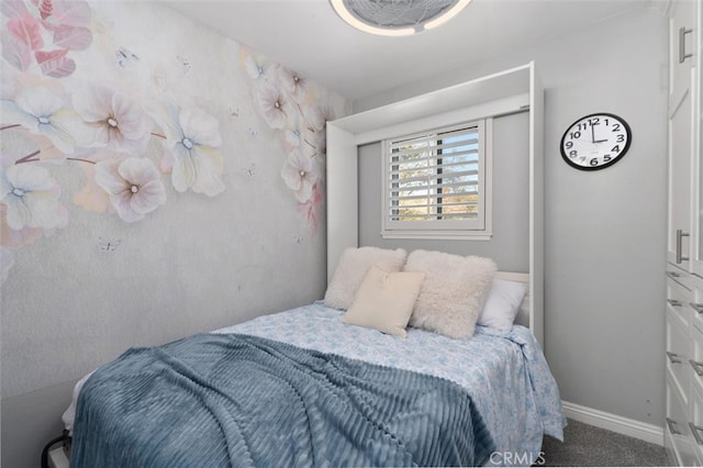 bedroom featuring carpet and baseboards