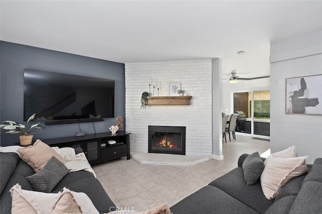 living room with light tile patterned floors, a brick fireplace, and a ceiling fan