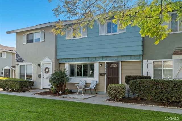 view of property featuring a front yard