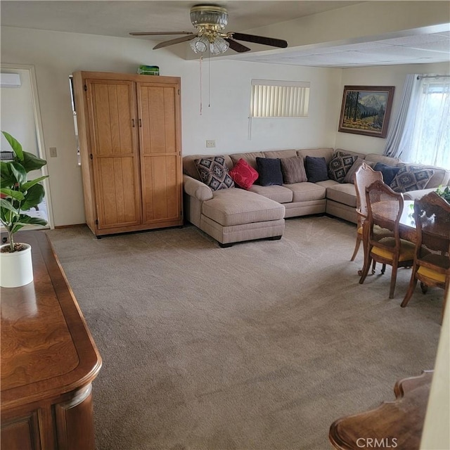 living area featuring light carpet and ceiling fan