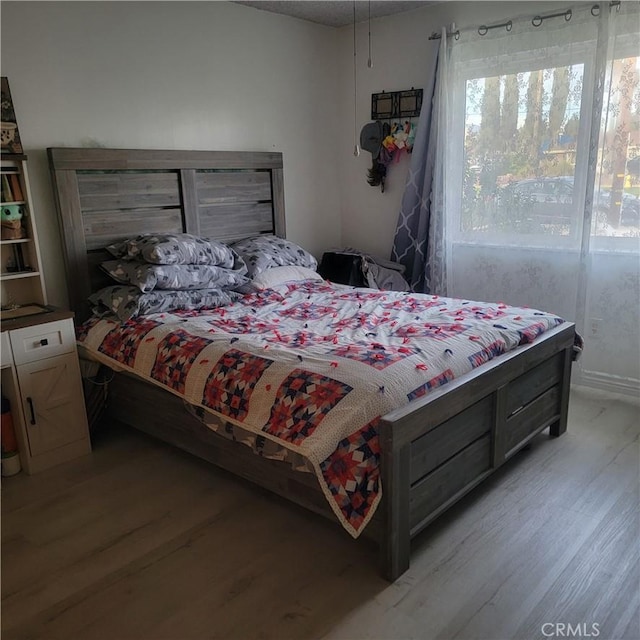 bedroom with light wood-type flooring