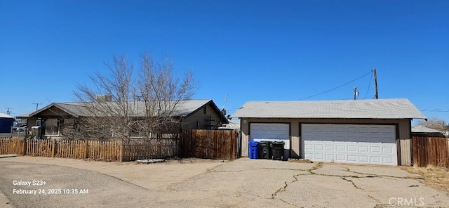 detached garage featuring fence