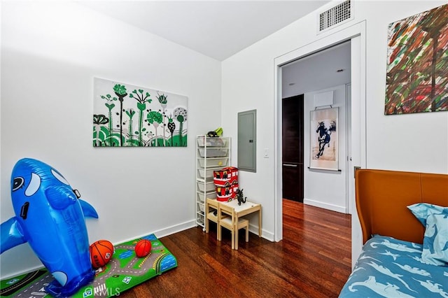 bedroom with dark wood-style floors, electric panel, visible vents, and baseboards