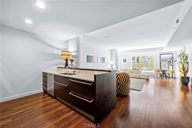 kitchen featuring a sink, baseboards, open floor plan, modern cabinets, and dark wood finished floors