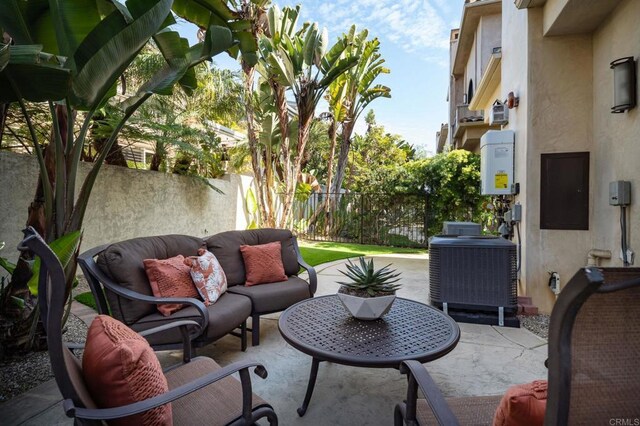 view of patio featuring a fenced backyard, an outdoor hangout area, and central AC