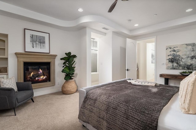 carpeted bedroom featuring visible vents, a glass covered fireplace, a ceiling fan, and recessed lighting