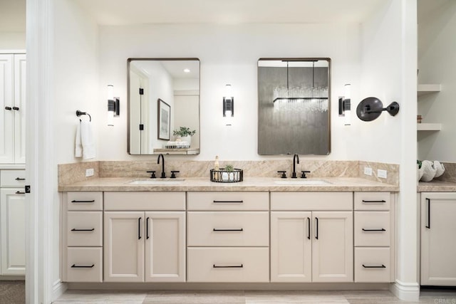 bathroom featuring a sink and double vanity