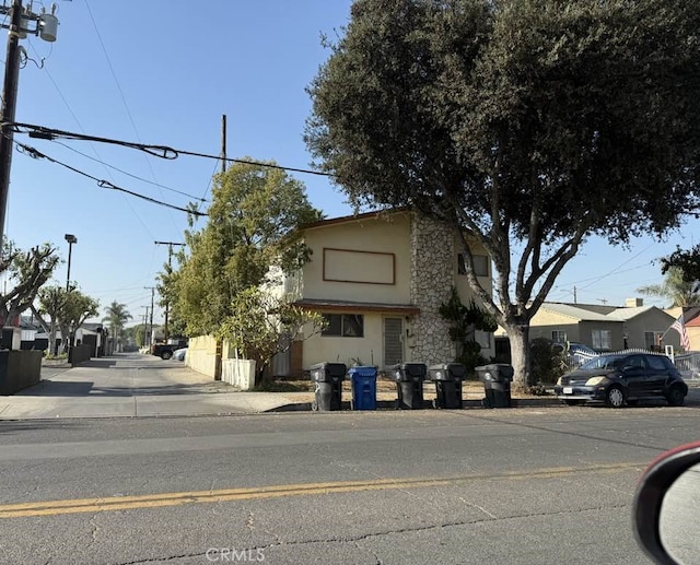 view of front facade featuring a residential view and stucco siding