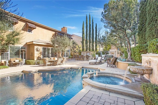 view of swimming pool featuring outdoor dining space, exterior bar, a patio area, and a pool with connected hot tub