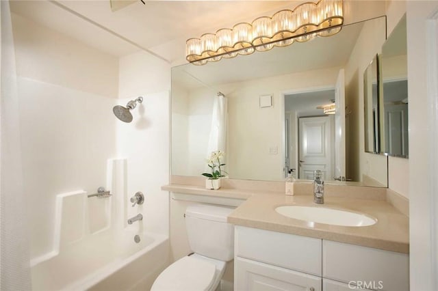 full bath with toilet, vanity, and bathing tub / shower combination