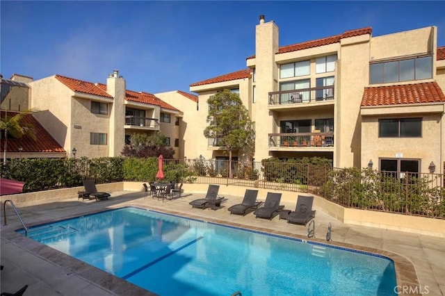 pool featuring a patio and fence