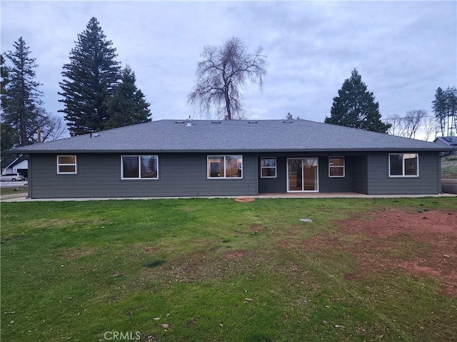 rear view of house with a yard and a patio area