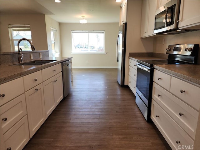 kitchen with white cabinets, stainless steel appliances, plenty of natural light, and a sink