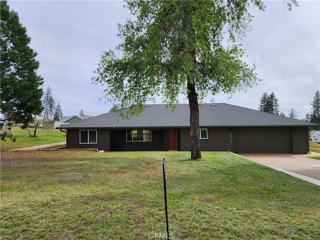 single story home featuring a garage, concrete driveway, and a front lawn