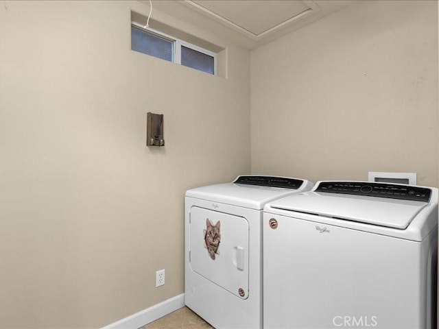 laundry room with baseboards, separate washer and dryer, and laundry area