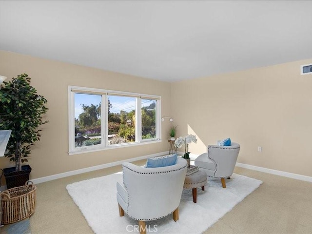 sitting room featuring baseboards, carpet floors, and visible vents