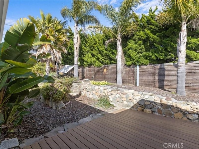 wooden deck featuring a fenced backyard