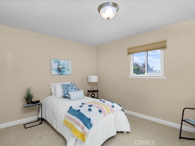 bedroom featuring carpet flooring and baseboards