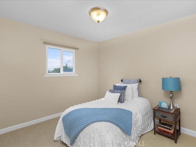 bedroom featuring baseboards and carpet floors