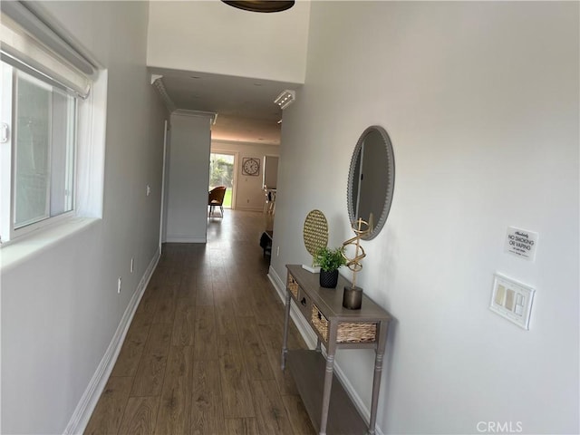 corridor with dark wood-type flooring and baseboards