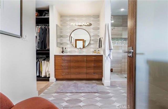 bathroom featuring a shower stall and vanity