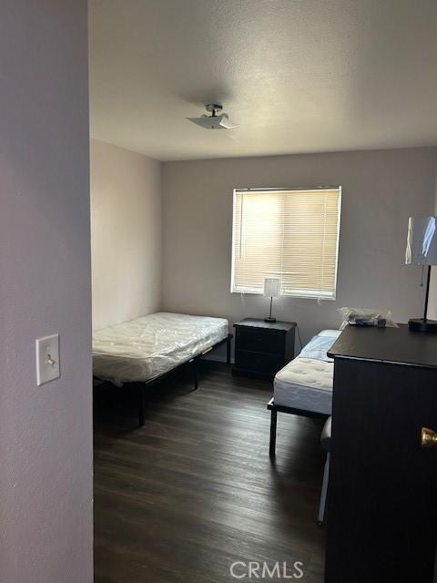 bedroom with dark wood-style floors