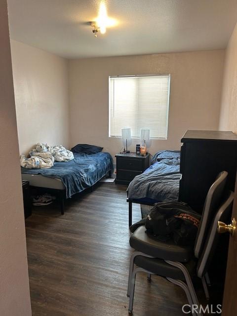 bedroom featuring dark wood-style flooring