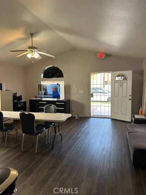 dining room featuring lofted ceiling, dark wood-style floors, and a ceiling fan