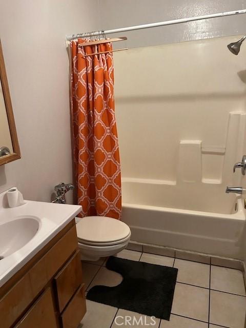 bathroom featuring shower / tub combo, vanity, toilet, and tile patterned floors