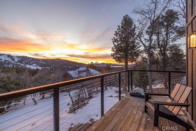 snow covered deck featuring a mountain view