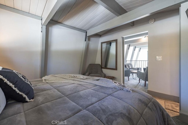 carpeted bedroom featuring vaulted ceiling with beams, wood ceiling, and baseboards